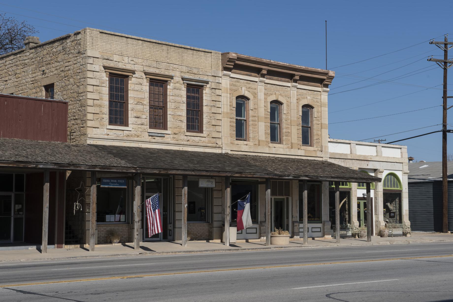 The stone facade and shaded entrance of Albany City Hall in Texas